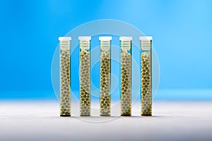 Five small glass tubes with homeopathy globules