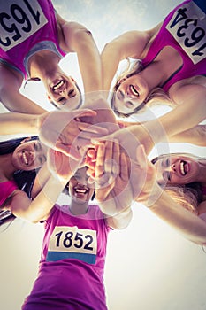 Five smiling runners supporting breast cancer marathon