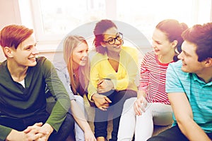 Five smiling teenagers having fun at home