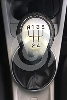 Five-speed manual shifter in the car. Inside car, gear shifter close up