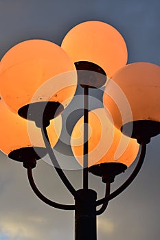 Five spherical lamps on post