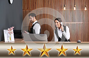 Five Star Luxury Hotel. Receptionists working at desk photo