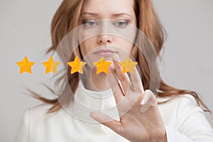 Five star rating or ranking, benchmarking concept. Woman assesses service, hotel, restaurant