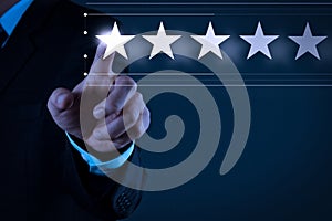 Five stars 5 rating with a businessman is touching virtual computer