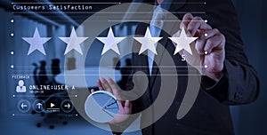 Five stars 5 rating with a businessman is touching virtual computer screen.