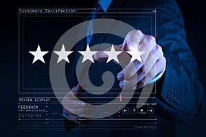 Five stars 5 rating with a businessman is touching virtual computer screen