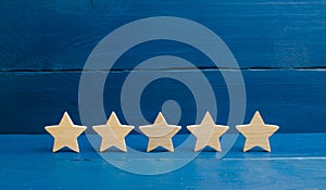 Five stars on a blue background. The concept of rating and evaluation. The rating of the hotel, restaurant, mobile application. Qu