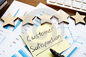 Five stars and customer satisfaction. Documents on a desk photo