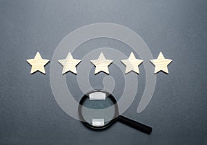 Five stars and a magnifying glass. Rating of hotels and restaurants, expensive institutions. Fame and uniqueness, attracting