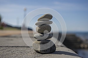 Five stones cairn tower, rock zen sculpture, brown beige pebbles