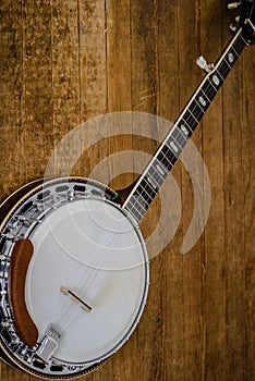 Five String Banjo on hardwood floor