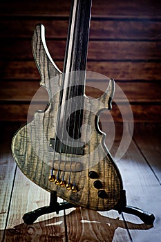 Five-string electric dark wood bass. Background for music and creativity