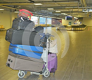 Five Suitcases stacked on top of each other depicting difficulties traveling with lots of luggage
