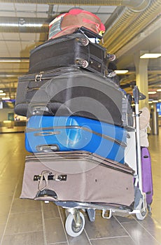 Five Suitcases stacked on top of each other depicting difficulties traveling with lots of luggage