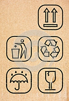 Five symbol on cardboard - This Way Up, Do Not Litter, Recycling, Keep Dry and Fragile