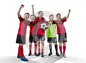 Five teenage soccer players celebrating victory on white