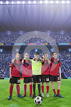 Five teenage soccer players on a soccer field