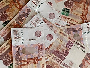 Five thousand banknotes in Russian rubles are spread out on the table