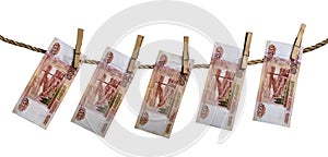 Russian rouble banknotes hanging on a clothesline with clothes pegs isolated on white background