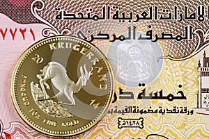 Five UAE dirham bank note with a golden Krugerrand coin