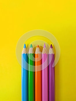 Five watercolor pencil with yellow background