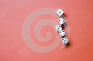 Five white dice on an orange background. Combination: low street photo