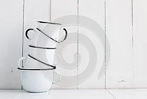 Five white enameled mugs