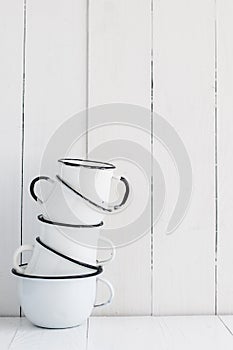 Five white enameled mugs