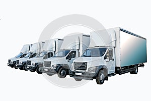 Five white truckers in the parking lot are waiting for the next delivery of goods. The concept of a transport company for the