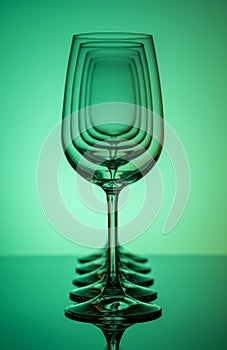 Five wine glasses silhouette in row concentric on green background