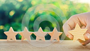 Five wooden stars. Get the fifth star. The concept of the rating of hotels and restaurants, the evaluation of critics and visitors