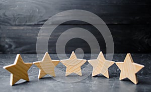 Five wooden stars. Get the fifth star. The concept of the rating of hotels and restaurants, the evaluation of critics and visitors