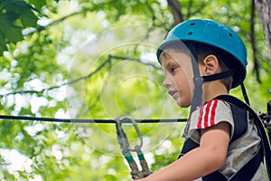 Five year boy on rope-way in forest