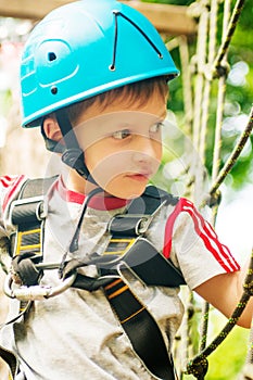 Five year boy on rope-way in forest