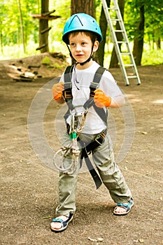 Five year boy on rope-way in forest