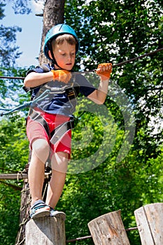 Five year boy on rope-way in forest