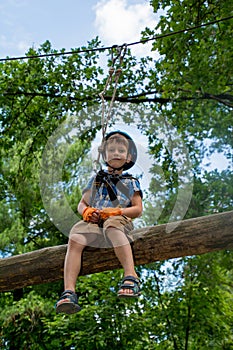 Five year boy on rope-way in park