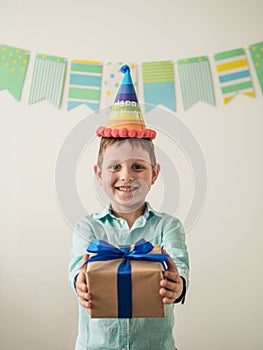 Five year old boy in his birthday hold gift box