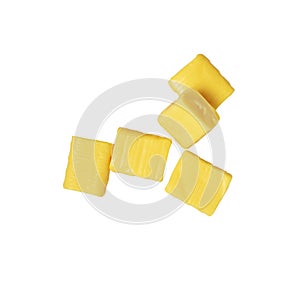 Five yellow rectangular chewy candy isolated on a white, mamba