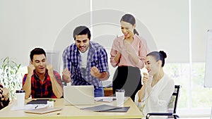 Five young startup team giving high five in modern office