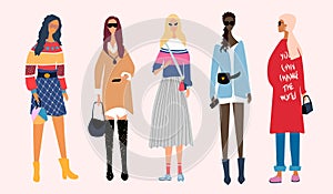 Five young women or girls dressed in trendy, fashionable clothes standing together. Group of female friends, feminists.