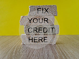 Fix your credit here symbol. Concept words Fix your credit here on brick blocks