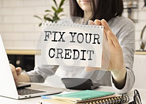 Fix Your Credit placard on white notepad