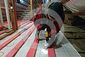Fixation and warming of the attic, fixation of the waterproofing film on the attic with the help of boards and screws