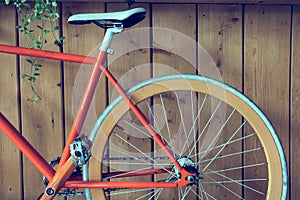 Fixed gear bicycle parked with wood wall, close up image