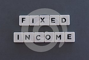 Fixed Income word made of square letter word on grey background