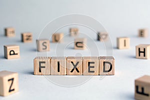 Fixed - word from wooden blocks with letters