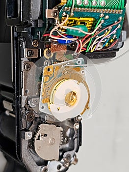 Fixing a camera. Exposed insides of an slr camera. Broken part. Electronics. Mechanics.