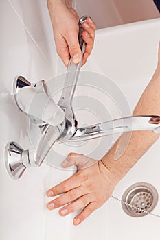 Fixing water tap with spanner