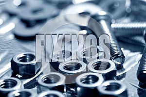 Fixings written on top of nuts and bolts in blue